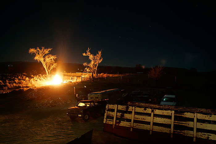 Canon EOS 1D MarkII — ISO 100 @ f/2.8 and 13sec — A bonfire lights up the surroundings in the Colorado desert.