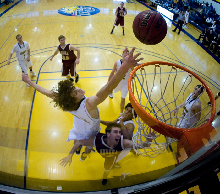 Honorable Mention Sports - Gorlok forward Steve Hrdlicka jumps to block a shot by the Eureka College Red Devils. Webster lead by 20 points at the half and closed out the game be increasing the lead to 30 points.
