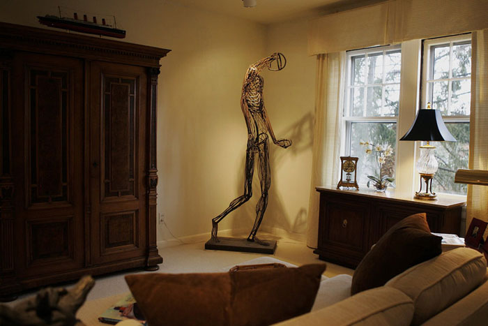 The sitting room in the home of interior designer nEdwin Massie icludes  a life size metal human designed by a local artist. ©2009 Max Gersh | St. Louis Post-Dispatch