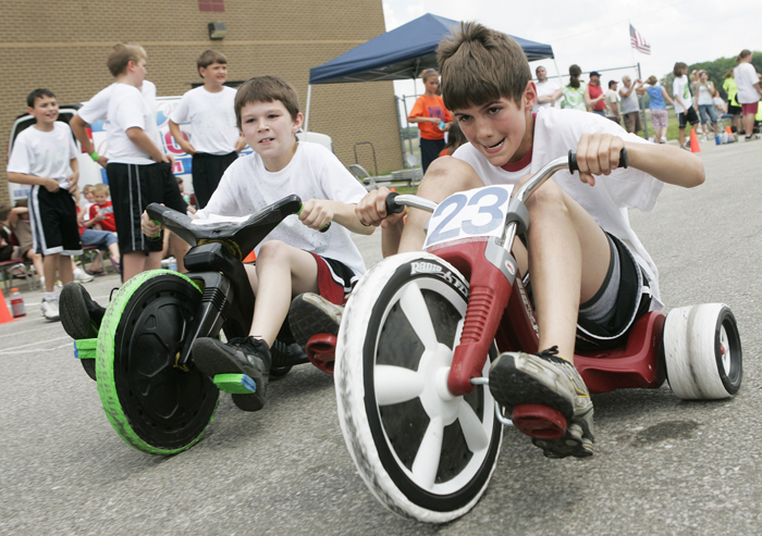 In this May 26, 2010 photo, Grant Jessup, number 23, pedals past his competition during the Titan 500, a 50 lap Big Wheel tricycle race at Tri Elementary School in Straughn, Ind. (AP Photo/The Courier-Times, Max Gersh) ©2010