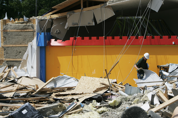 An Indianapolis based civil engineer searches through rubble at the site where Big Bounce Inflatables collapsed Thursday afternoon. He said that it is difficult to distinguish what damage was done during the collapse from what was done by bulldozers. (C-T photo Max Gersh) ©2010