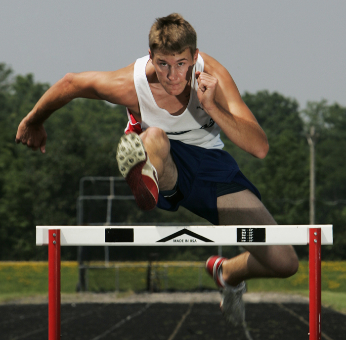 Blue River Valley's J.T. Griggs leaps a hurdle June 25 at the BRV track. Griggs won three events in the Henry County track meet this year. ©2010