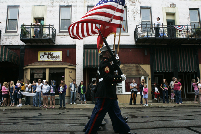 U.S. Marines carry flags down Main Street in Middletown Tuesday evening as part of the parade during the Middletown Lions Club Fair. (C-T photo Max Gersh) ©2010