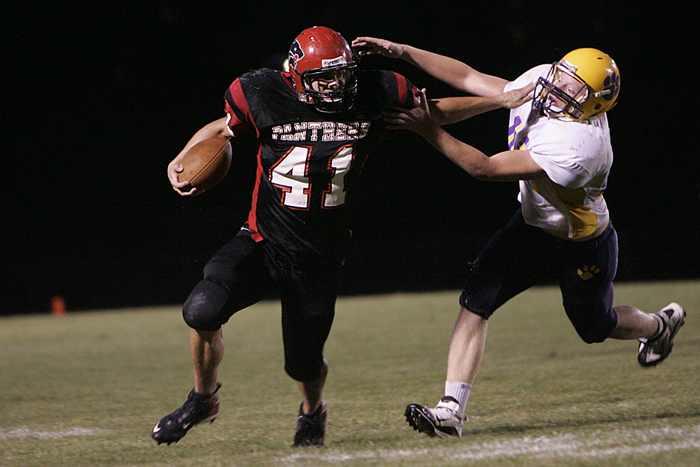 Knightstown's running back stiff-arms a Hagerstown defender. (C-T photo Max Gersh) ©2010