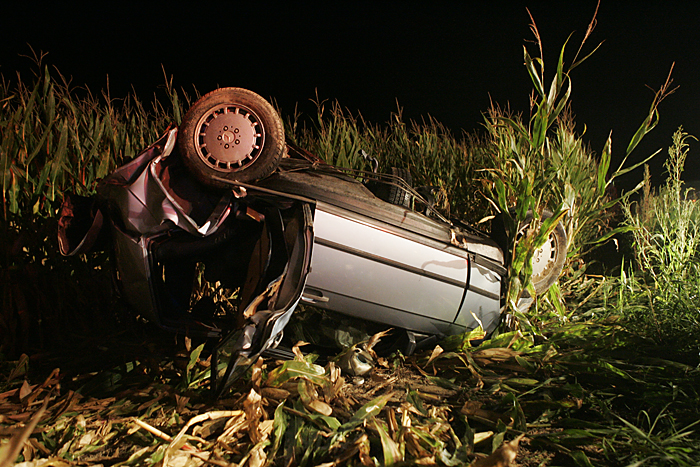 A 1987 Mercedes Benz lies mangled in a cornfield late Wednesday night after crashing near the intersection of Road 300S and Ind. 103. (C-T photo Max Gersh) ©2010