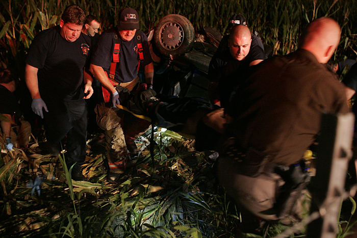 Emergency respodners carry Jimmy Luna, 17, New Castle, from a mangled vehicle to a waiting ambulance Wednesday night near the intersection of Road 300S and Ind. 103. (C-T photo Max Gersh) ©2010