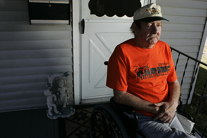 Bud Bush, who frequently participates in the Henry County Day of Caring, sits on his front porch Thursday afternoon next to a new ramp that was built for him by volunteers. (C-T photo Max Gersh) ©2010