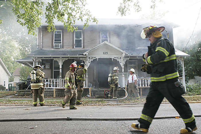 Firefighters finish extinguishing a house fire Thursday afternoon in Spiceland. The homeowners were downstairs when a neighbor alerted them of the fire which was visible in the upstairs windows. (C-T photo Max Gersh) ©2010