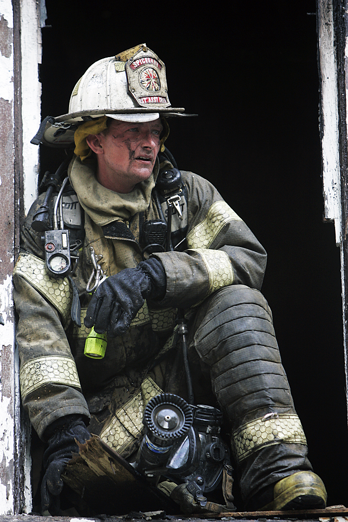 Joey Cunningham, assistant fire chief at the Spiceland Volunteer Fire Department, looks out a second story window Thursday afternoon after extinguishing a house fire in Spiceland. (C-T photo Max Gersh) ©2010