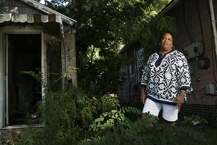 Lisa Archey stands in between two abandoned and neglected homes on August 25 along North 17th Street. Archey said that having homes like these on the block hurt the entire community. (C-T photo Max Gersh) ©2010