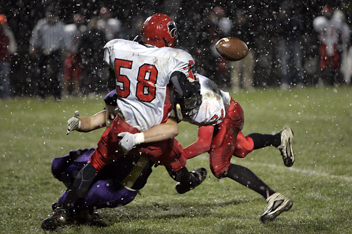 A Hagerstown defender pops the ball out of the arms of Knightstown's #58 Friday night. (C-T photo Max Gersh) ©2010