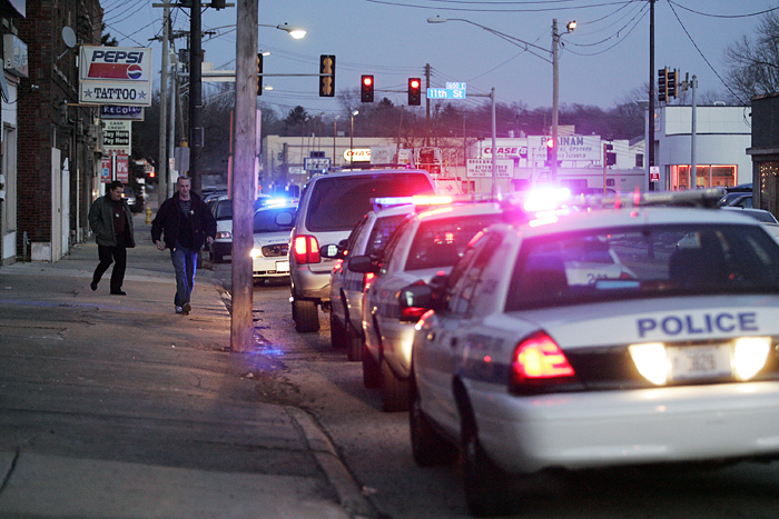 MAX GERSH | ROCKFORD REGISTER STAR ©2011 Police officers leave The Happy Shop Thursday, Jan. 6, 2011,  after responding to a shooting on the 1500 block of Broadway in Rockford.