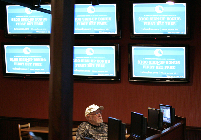 MAX GERSH | ROCKFORD REGISTER STAR ©2011 Clarence Holmes watches horse races Monday, Jan. 10, 2011, at the off track betting facility at Don Carter Lanes in Rockford.