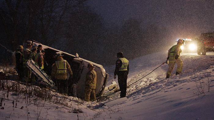 MAX GERSH | ROCKFORD REGISTER STAR ©2010 Blackhawk firefighters work to free a man trapped in a gray Chevrolet Malibu Monday night on US Bypass 20 at near Simpson Road. Fire Chief Harry Tallacksen said the driver's injuries weren't critical.