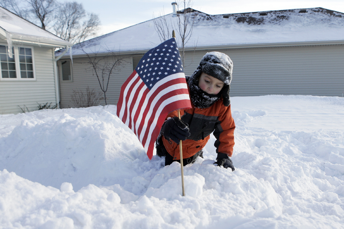 MAX GERSH | ROCKFORD REGISTER STAR Mason Caltagerone, 4, places a flag on top of a snow fort Wednesday, Feb. 2, 2011,  in front of his family's home on Ann's Acres in Rockford. ©2011