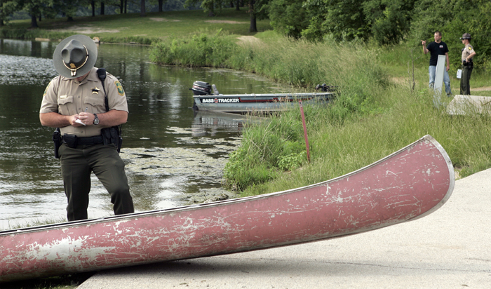 MAX GERSH | ROCKFORD REGISTER STAR A conservation officer looks at a canoe Tuesday, June 14, 2011, at a boat dock in Rock Cut State Park in Loves Park. A 17-year-old boy that was pulled from the water had been riding in the canoe. ©2011