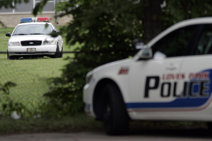 MAX GERSH | ROCKFORD REGISTER STAR Police officers search the wooded area on the east side of Hannah Court for a man Friday, June 24, 2011, after being suspected of the armed robbery of Associated Bank in the in the 6200 block of North Second Street in Loves Park. ©2011