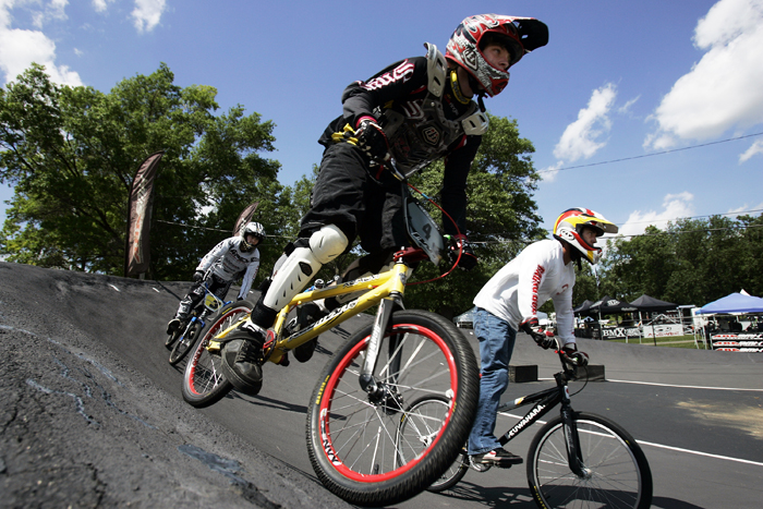 MAX GERSH | ROCKFORD REGISTER STAR Brandon Ceslok (center), 15, of Janesville, Wis., takes the outside edge on a turn Thursday, June 16, 2011, during practice runs for the ABA BMX Midwest Nationals at Searls Park in Rockford. ©2011