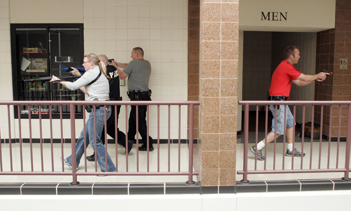 MAX GERSH | ROCKFORD REGISTER STAR Officers cover a hallway Wednesday, Aug. 10, 2011, during rapid deployment to an active shooter training at Harlem High School in Machesney Park. ©2011