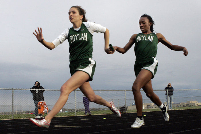 MAX GERSH | ROCKFORD REGISTER STAR Boylan's Eleyia Manns (right) hands the baton to Bryn Bauling during the 4x100 meter relay Thursday, May 5, 2011, during the NIC-10 girls championship meet at Belvidere North High School. © 2011