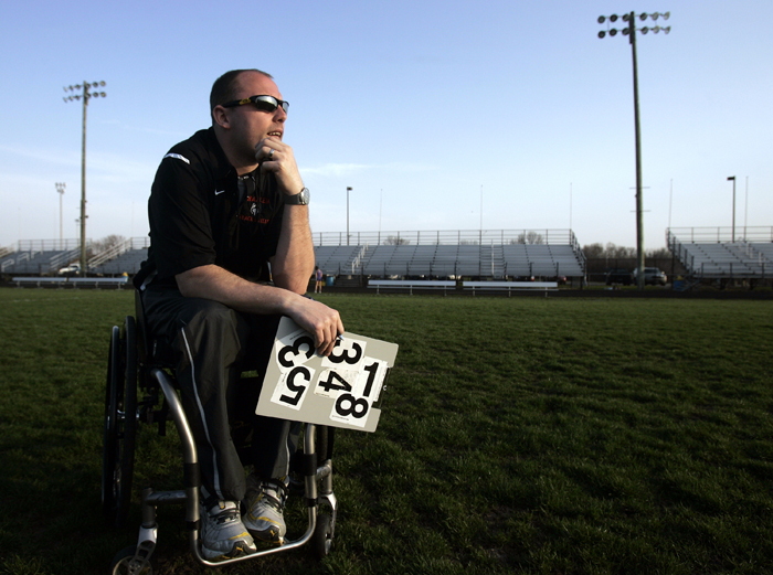 MAX GERSH | ROCKFORD REGISTER STAR Harlem High School Assistant Track Coach Kelsey Lueshen watches a race Wednesday, April 13, 2011, from the infield at Hononegah High School in Rockton. ©2011