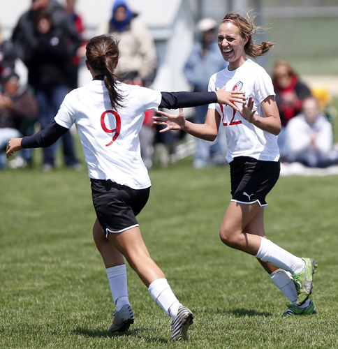 Stillman Valley's Tatum Glendenning (9) goes to hug teammate Abigail Timm (22) after Timm scored the team's second goal against Byron Saturday, May 11, 2013, during a game at Stillman Valley High School. MAX GERSH/ROCKFORD REGISTER STAR ©2013