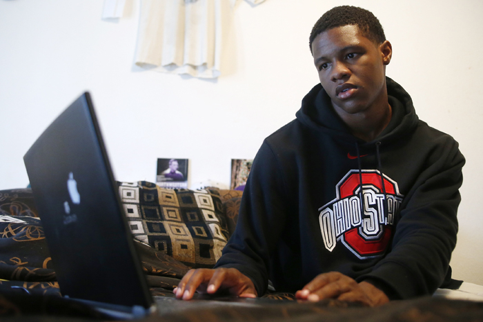 Cleveland Redd, 17, pulls up information for a U.S. history class project Tuesday, May 7, 2013, at his home in Rockford. Redd has had Comcast Internet Essentials for about four months which allows him to do school work at home. MAX GERSH/ROCKFORD REGISTER STAR ©2013