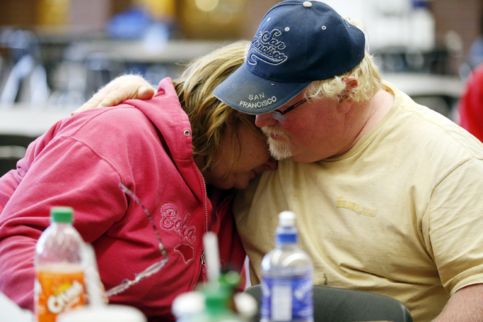 Marilyn Turner cries on her husband, Al's, shoulder after being evacuated to Pecatonica High School Sunday, June 2, 2013, in Pecatonica. The Turner's home sits in front of the Nova-Kem chemical plant. A firefighter told Marilyn that her 24 chickens had survived the the explosion and fire at the nearby plant. MAX GERSH/ROCKFORD REGISTER STAR ©2013