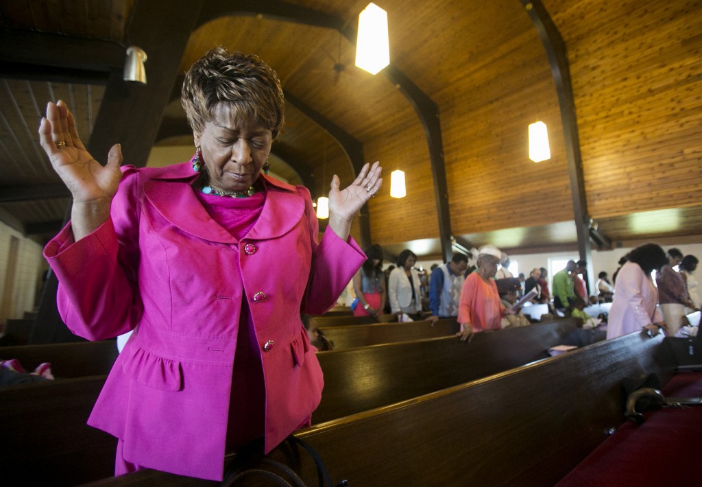 Dorothy Wright prays Sunday, April 20, 2014, during an Easter service at Pilgrim Baptist Church in Rockford. ©2014