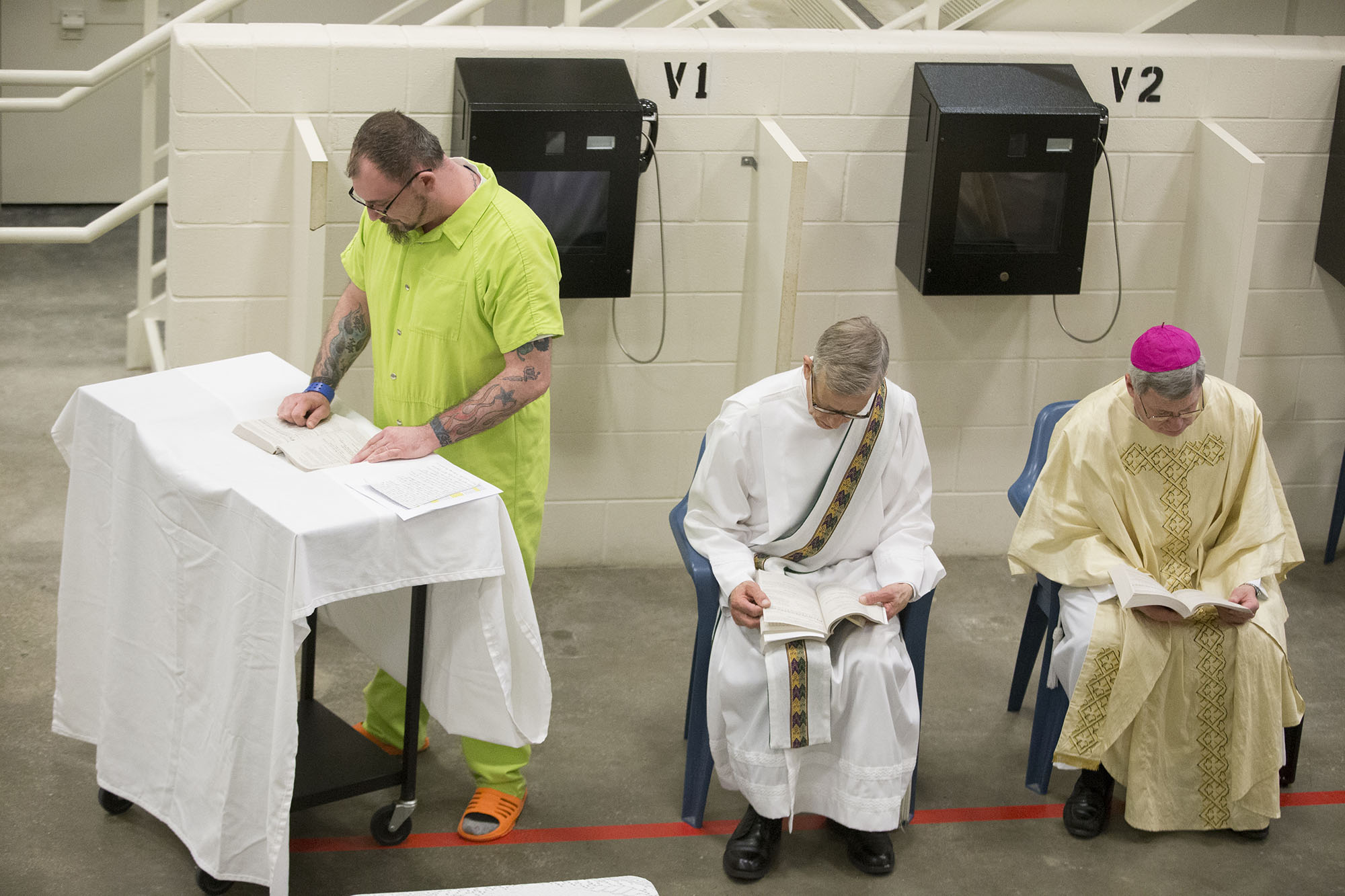 Ryan Rice Sr. reads Sunday, March 27, 2016, during Easter Mass at the Winnebago County Jail in Rockford. MAX GERSH/STAFF PHOTOGRAPHER/RRSTAR.COM ©2016