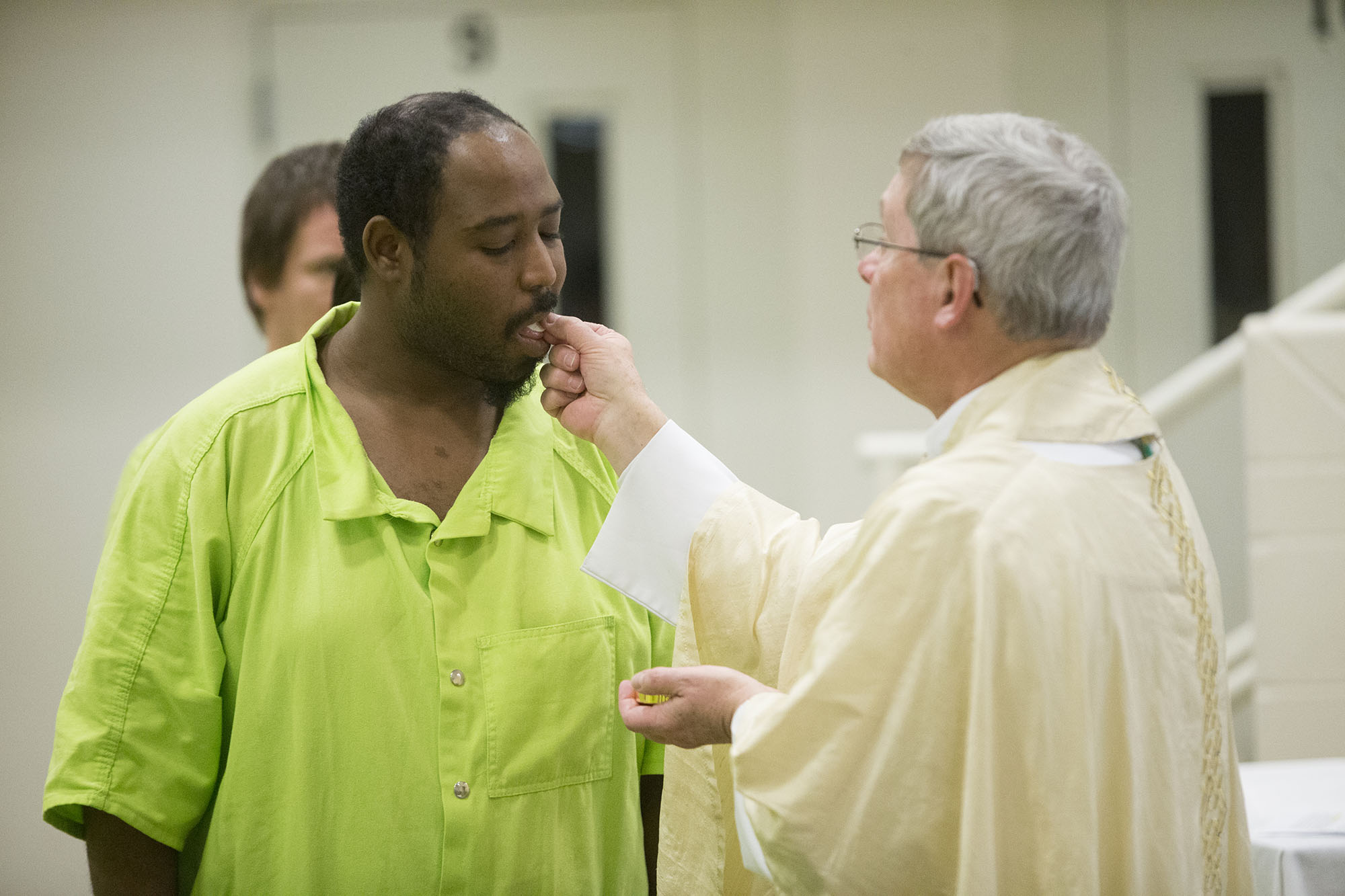 Cornelius Brooks receives communion from Bishop David J. Malloy on Sunday, March 27, 2016, during Easter Mass at the Winnebago County Jail in Rockford. MAX GERSH/STAFF PHOTOGRAPHER/RRSTAR.COM ©2016