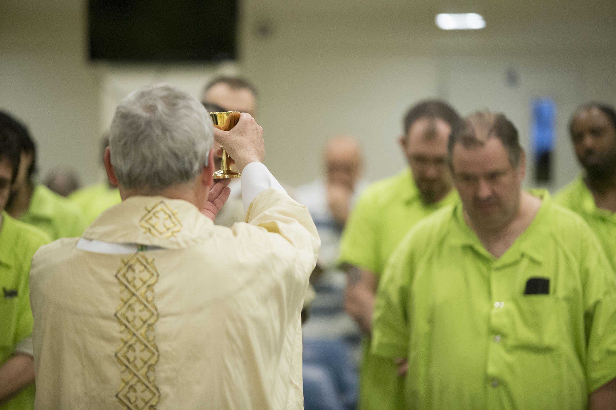Bishop David J. Malloy holds up a chalice Sunday, March 27, 2016, during Easter Mass at the Winnebago County Jail in Rockford. MAX GERSH/STAFF PHOTOGRAPHER/RRSTAR.COM ©2016